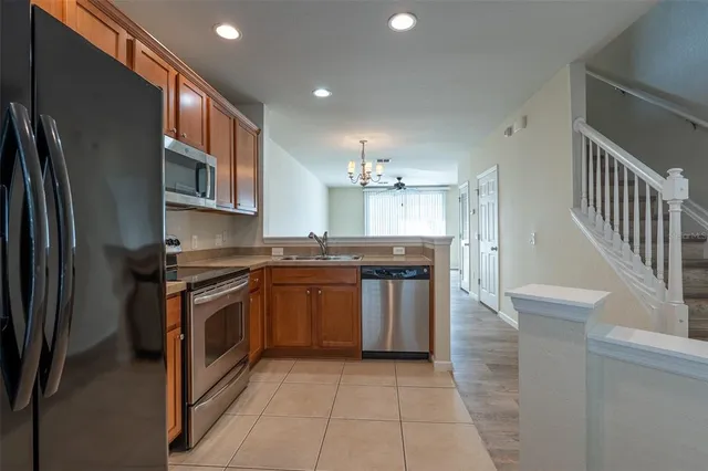 a kitchen with stainless steel appliances granite countertop a refrigerator and a stove