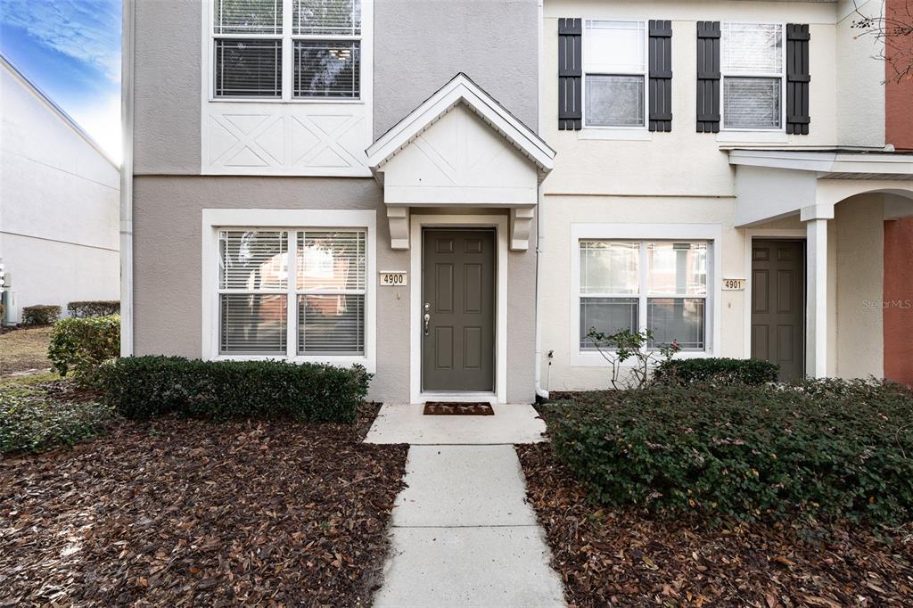 4900 Southwest 45th Street Ocala, FL 34474 - Photo 2 of 44 a view of a white house with large windows and plants