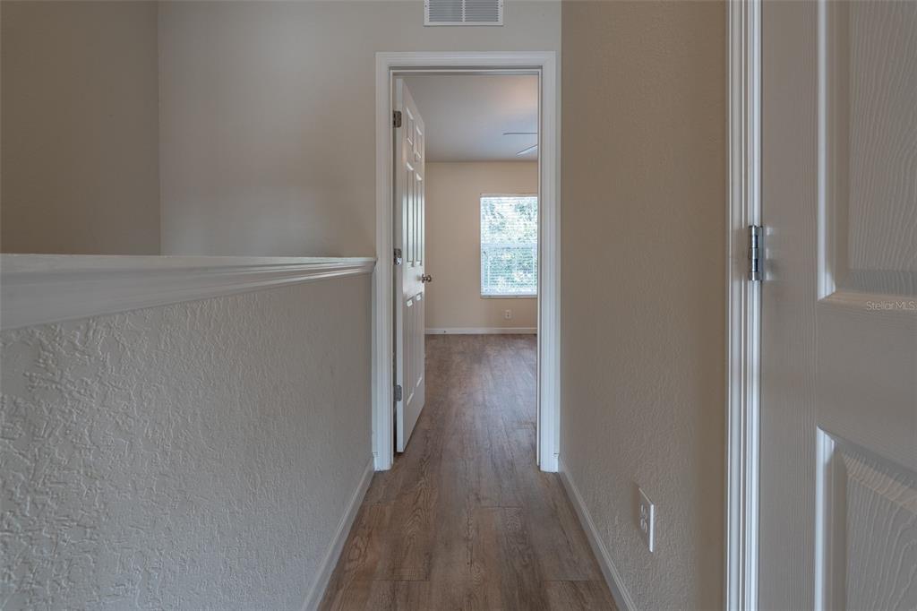 4900 Southwest 45th Street Ocala, FL 34474 - Photo 22 of 44 a view of a hallway with wooden floor