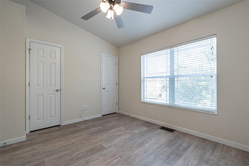 4900 Southwest 45th Street Ocala, FL 34474 - Photo 24 of 44 a view of an empty room with a window and wooden floor