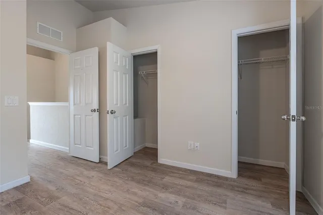 a view of an empty room with closet area