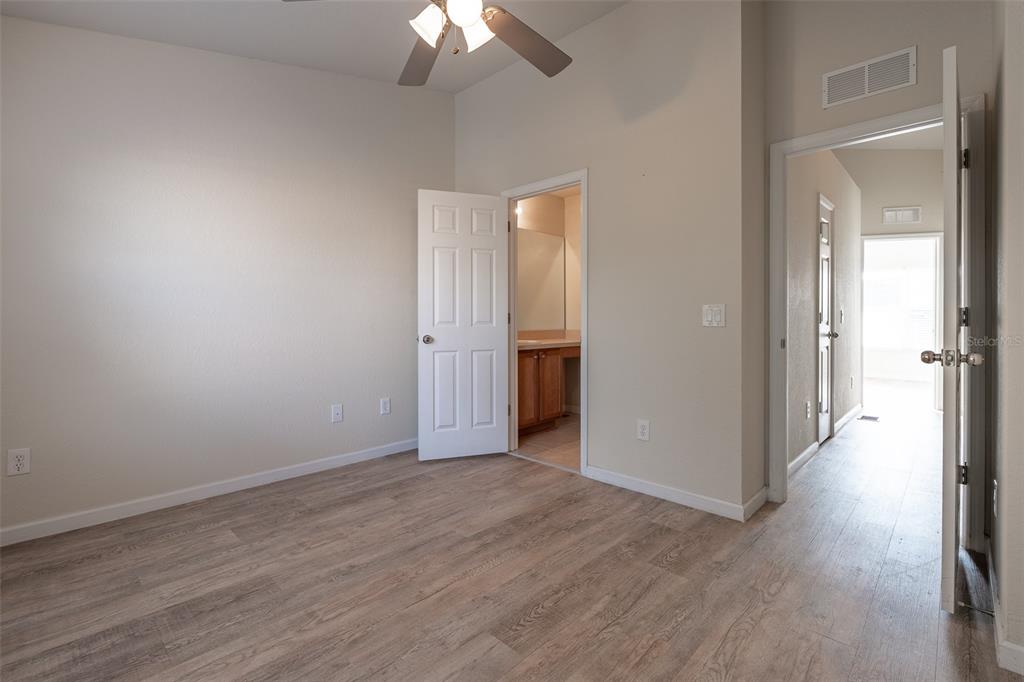 4900 Southwest 45th Street Ocala, FL 34474 - Photo 26 of 44 a view of a room with wooden floor and a ceiling fan