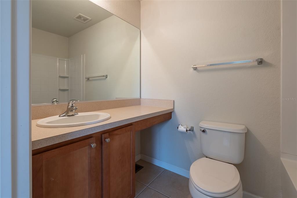 4900 Southwest 45th Street Ocala, FL 34474 - Photo 27 of 44 a bathroom with a sink a toilet and a mirror