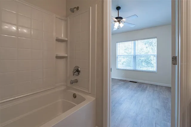 a bathroom with a bathtub and a shower