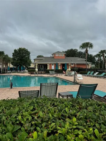 a swimming pool with outdoor seating and yard