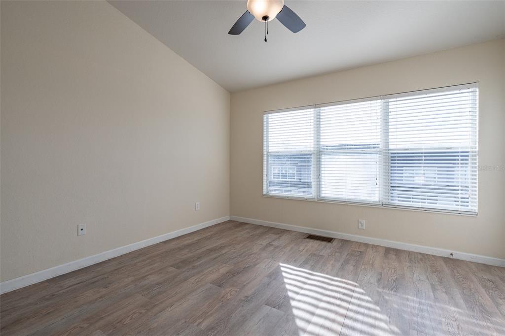 4900 Southwest 45th Street Ocala, FL 34474 - Photo 31 of 44 a view of an empty room with wooden floor and a window