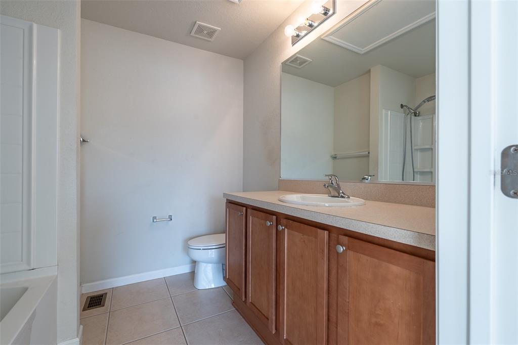 4900 Southwest 45th Street Ocala, FL 34474 - Photo 35 of 44 a bathroom with a sink a toilet and a mirror