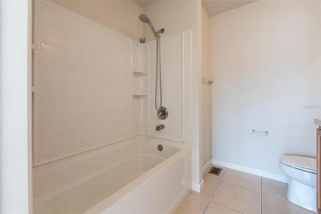 a bathroom with a bathtub and a toilet