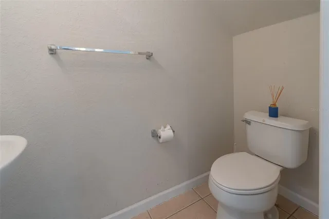 a white toilet sitting next to a shower