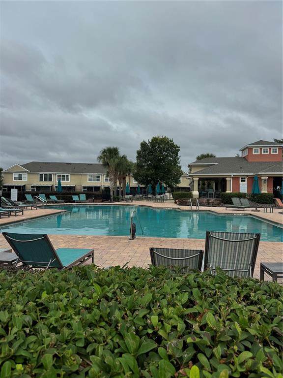 4900 Southwest 45th Street Ocala, FL 34474 - Photo 4 of 5 an outdoor view of house with swimming pool and outdoor seating