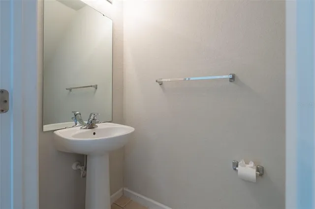 a bathroom with a sink a mirror and a window