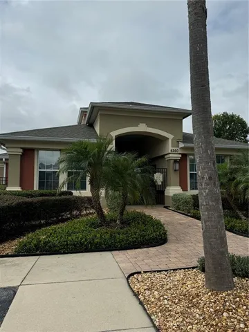 a front view of house with a garden