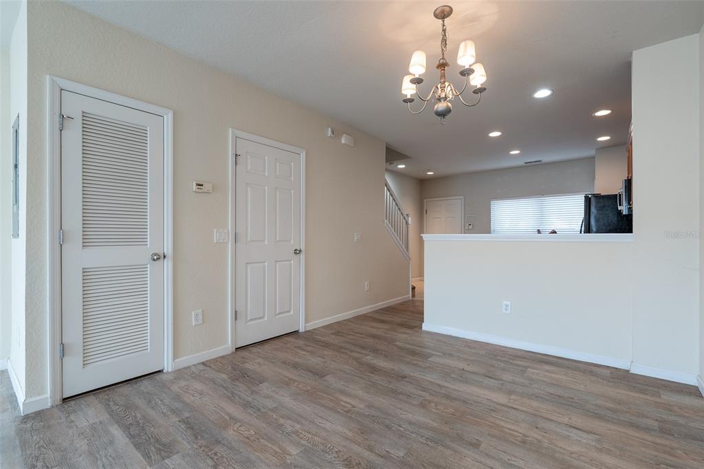 4900 Southwest 45th Street Ocala, FL 34474 - Photo 7 of 44 a view of a hallway with wooden floor and chandelier