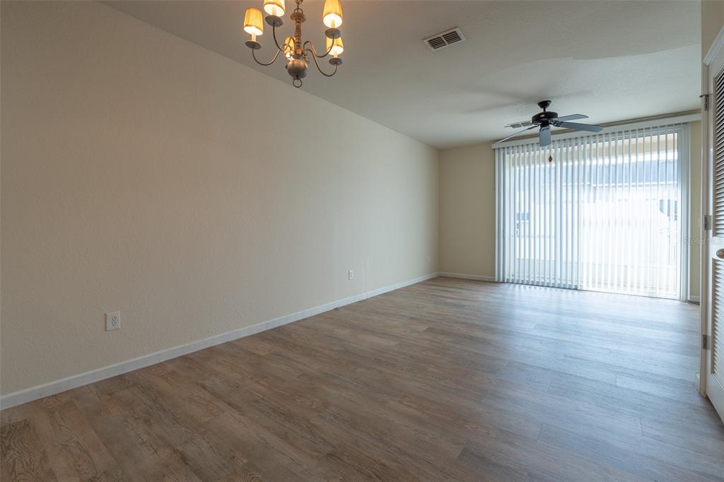 4900 Southwest 45th Street Ocala, FL 34474 - Photo 8 of 44 wooden floor in an empty room with a window