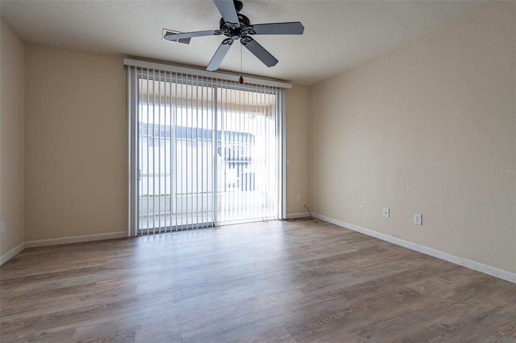4900 Southwest 45th Street Ocala, FL 34474 - Photo 9 of 44 wooden floor in an empty room with a window