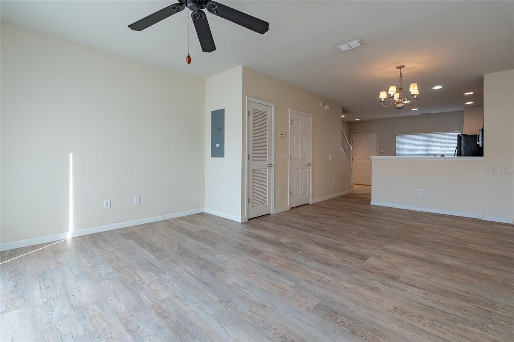 4900 Southwest 45th Street Ocala, FL 34474 - Photo 10 of 44 a view of an empty room with kitchen and chandelier