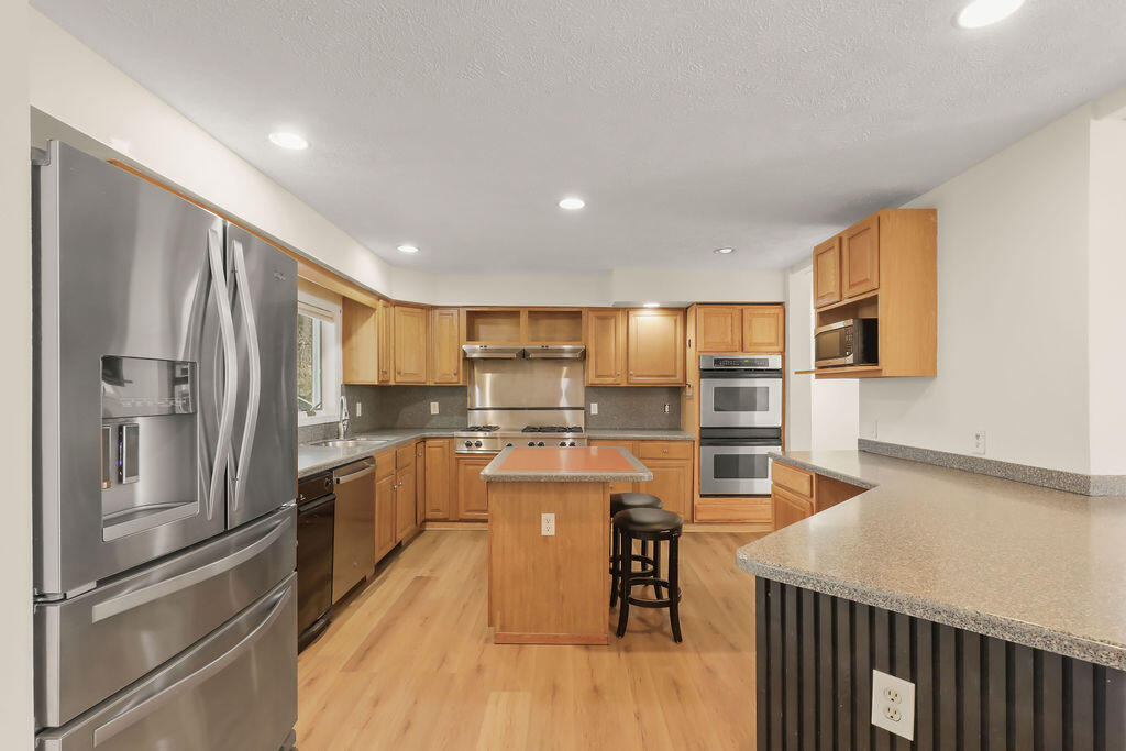 75 Edgewater Road Mashpee, MA 02649 - Photo 10 of 78 a kitchen with stainless steel appliances granite countertop a refrigerator a stove and a sink