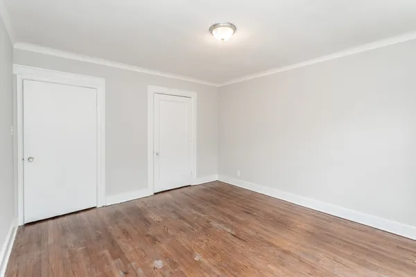 an empty room with wooden floor