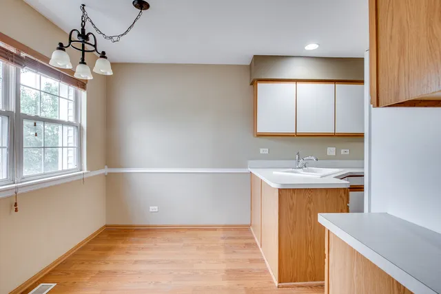 a kitchen with refrigerator cabinets and wooden floor