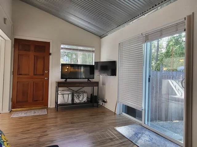a view of a living room with furniture and flat screen tv