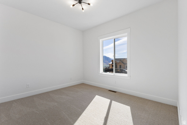 638 East Mountain Road North Ogden, UT 84414 - Photo 20 of 28 Carpeted spare room featuring baseboards and a mountain view