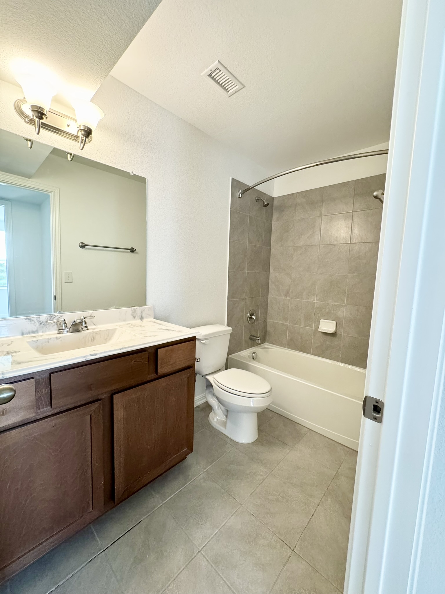 211 Martha Lane Kyle, TX 78640 - Photo 14 of 32 a spacious bathroom with a double vanity sink toilet mirror and shower