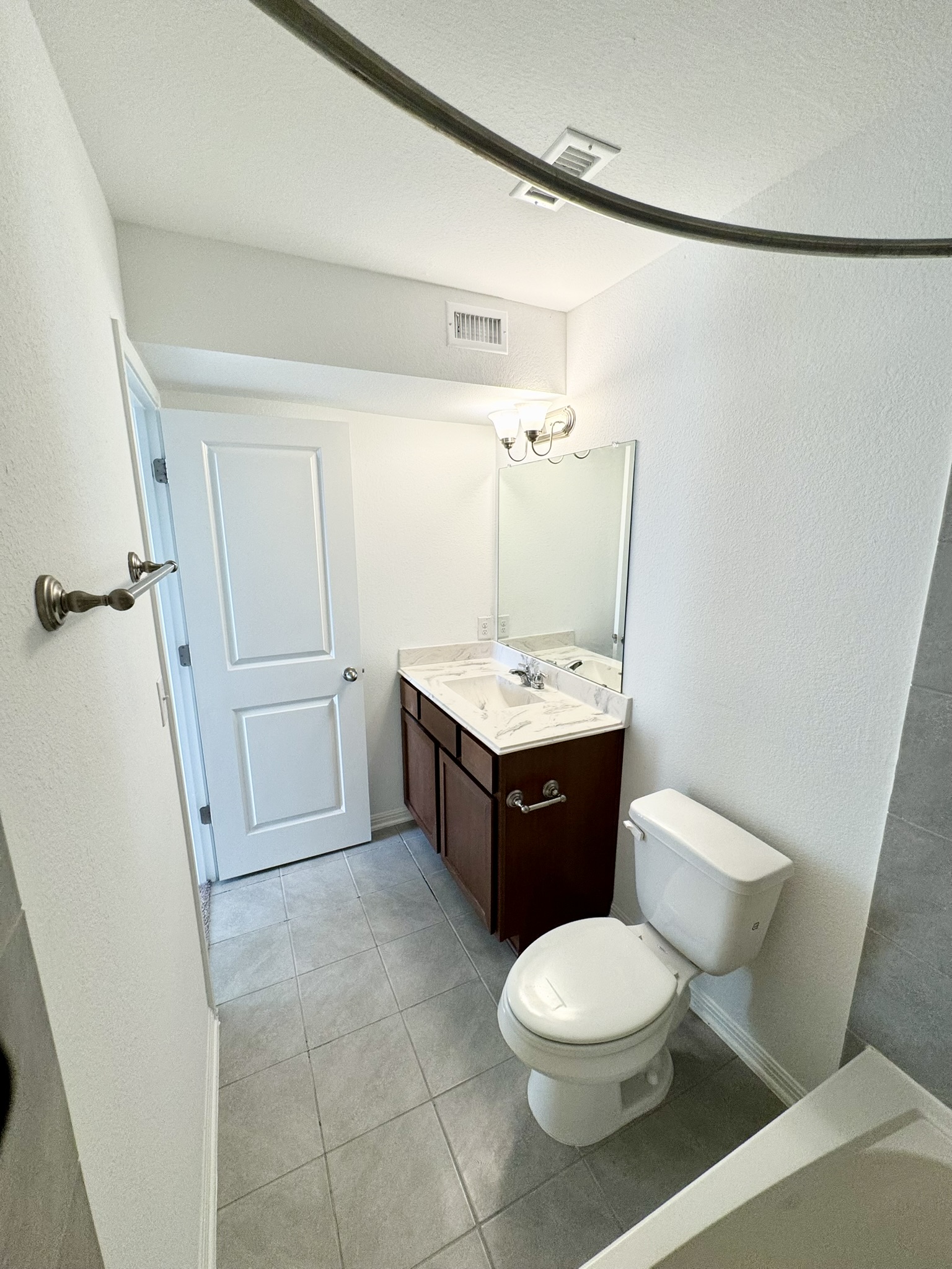 211 Martha Lane Kyle, TX 78640 - Photo 15 of 32 a bathroom with a sink a toilet and a mirror