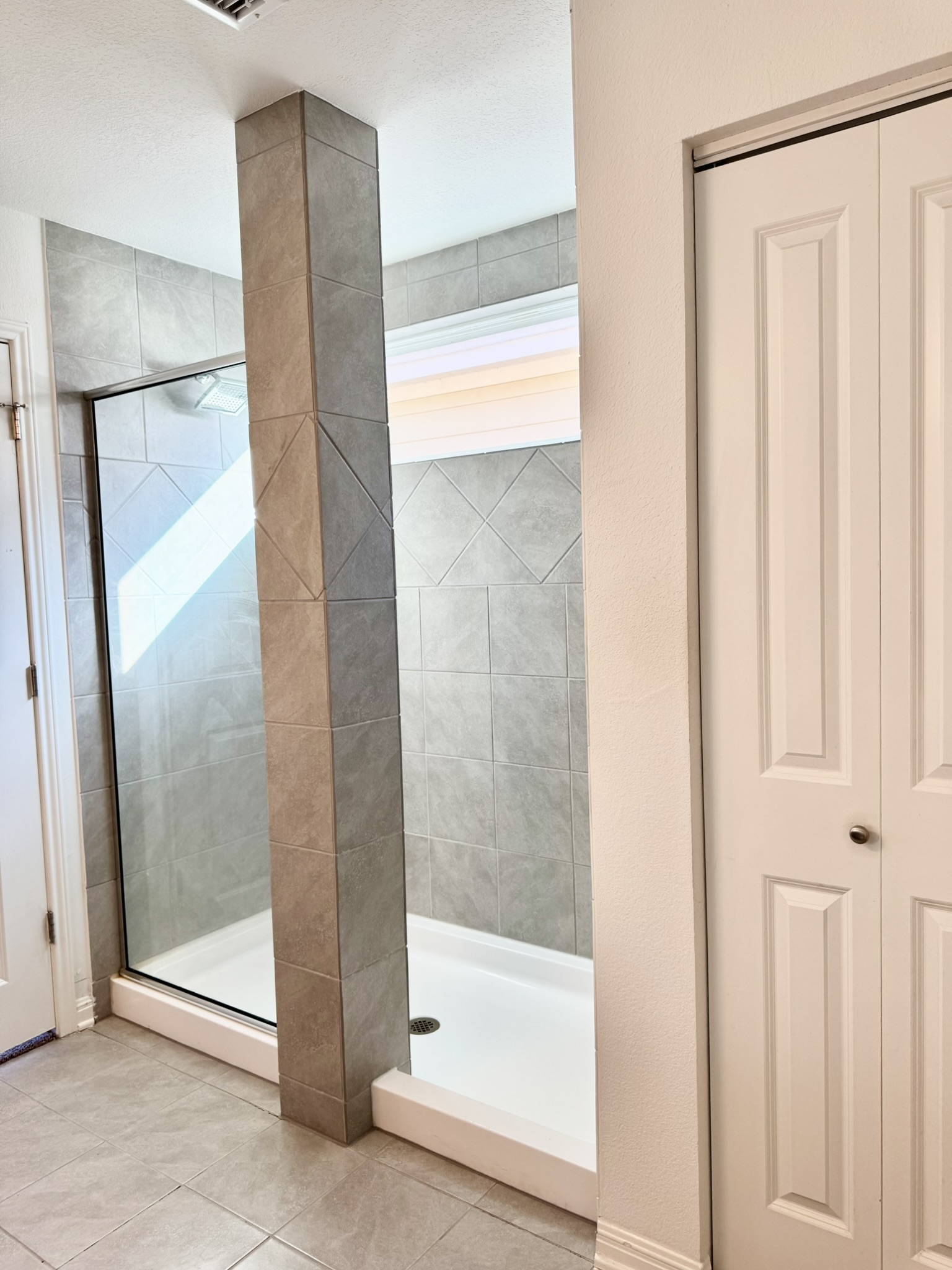 211 Martha Lane Kyle, TX 78640 - Photo 27 of 32 a bathroom with a glass shower door