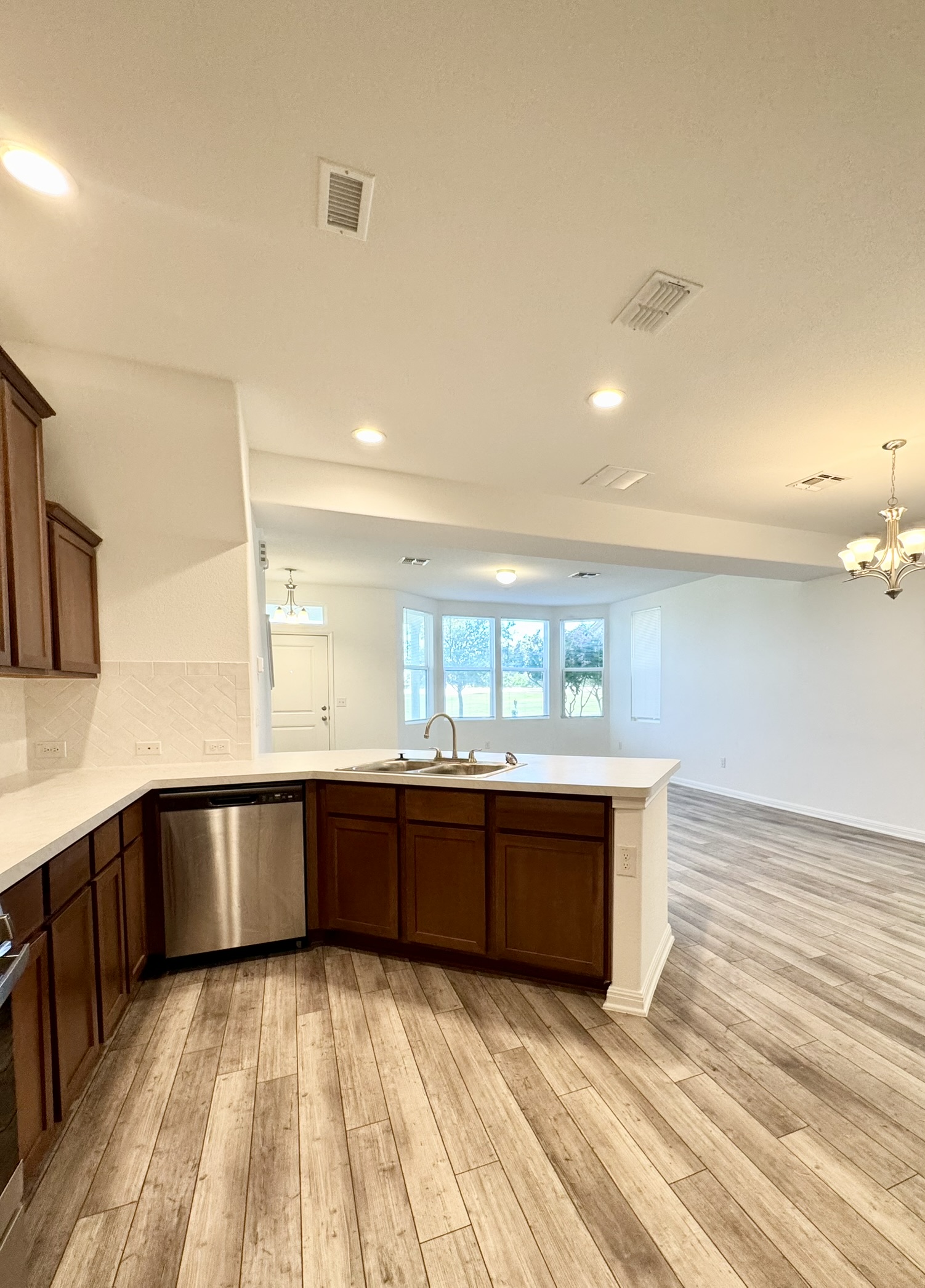 211 Martha Lane Kyle, TX 78640 - Photo 4 of 32 a large kitchen with stainless steel appliances granite countertop a sink and cabinets