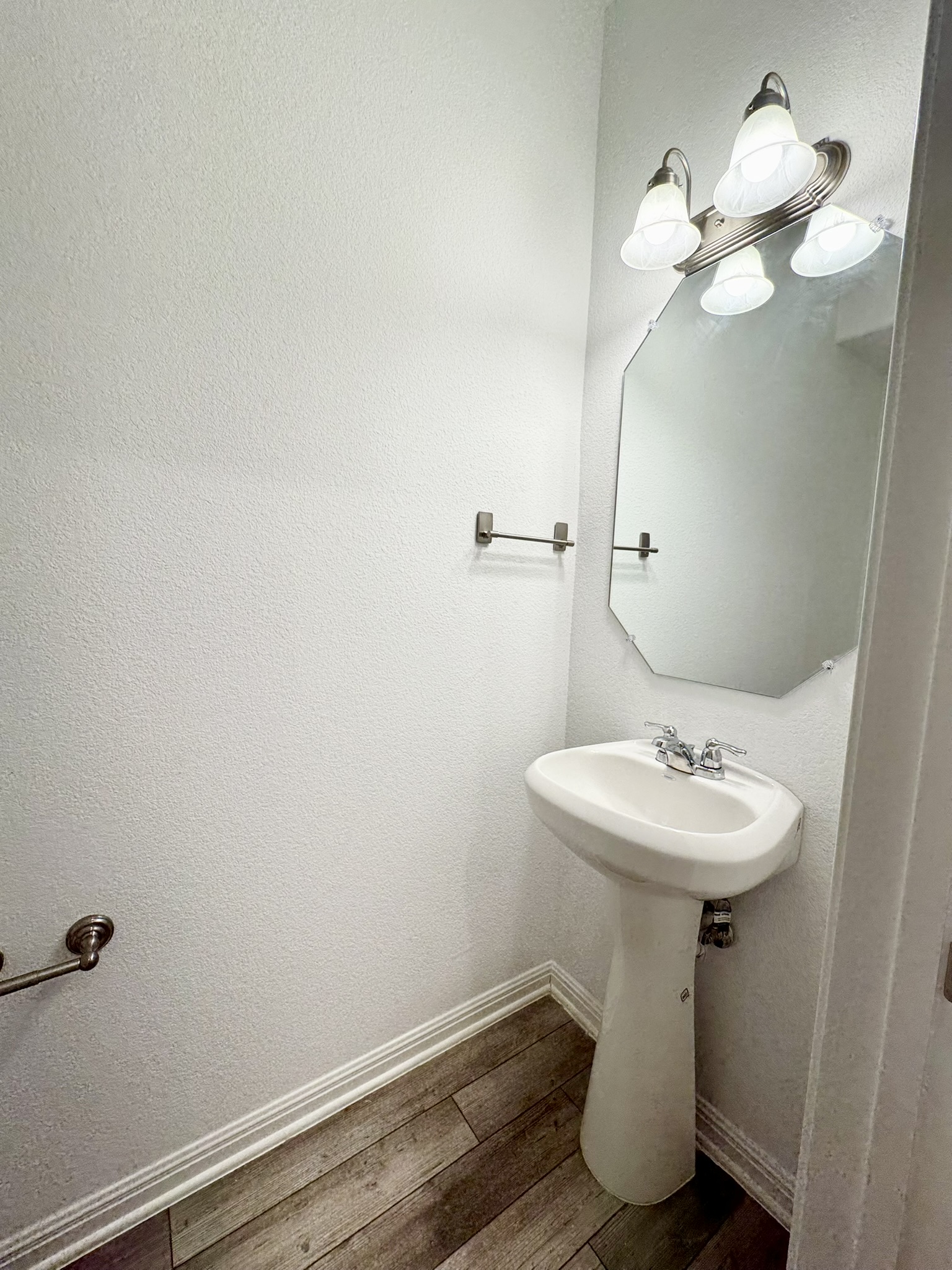 211 Martha Lane Kyle, TX 78640 - Photo 8 of 32 a bathroom with a sink a mirror and a toilet