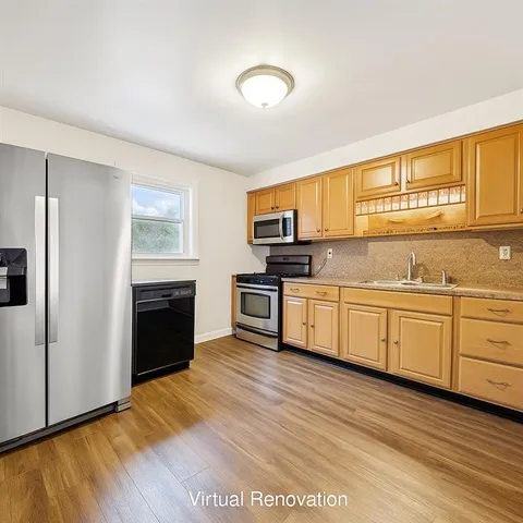 a kitchen with stainless steel appliances granite countertop a stove a sink and a refrigerator