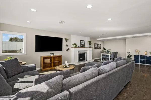 a living room with furniture a flat screen tv and a fireplace