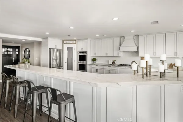 a large white kitchen with lots of counter space and window