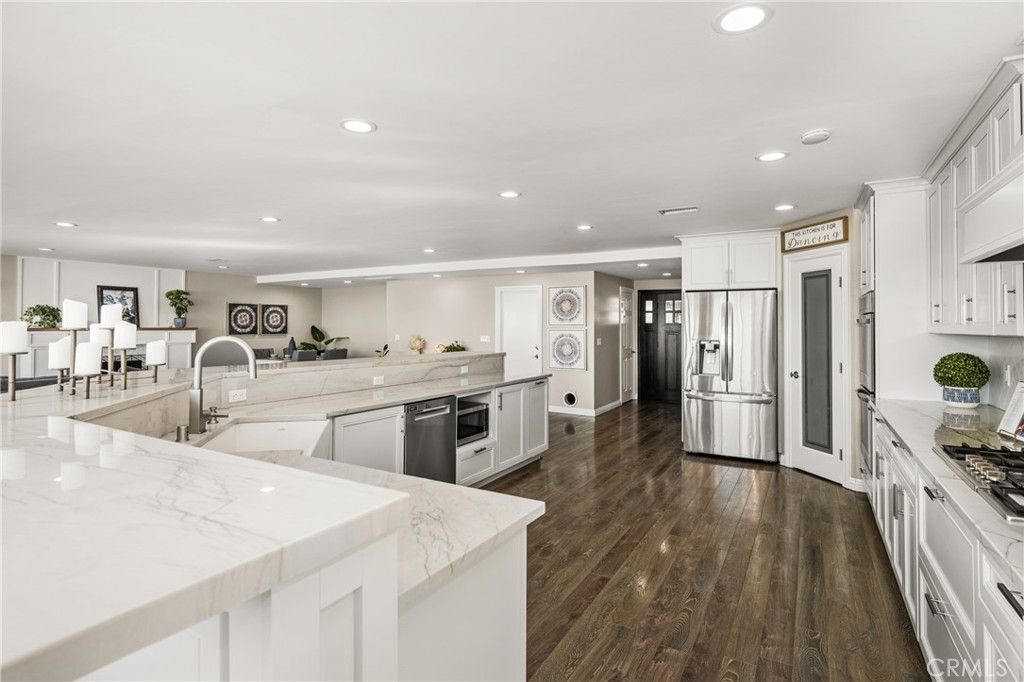 688 Buttonwood Drive Brea, CA 92821 - Photo 25 of 54 a kitchen with stainless steel appliances a stove a sink a refrigerator and cabinets