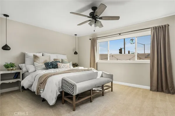 a bedroom with a bed and a ceiling fan