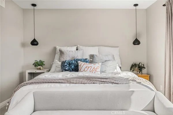 a bedroom with a bed and a chandelier