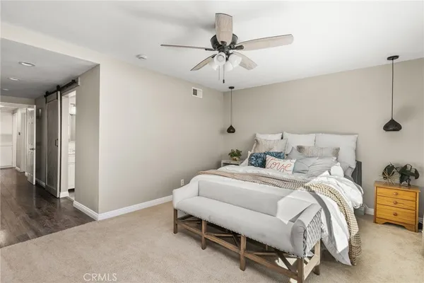 a bathroom with a granite countertop sink toilet and mirror