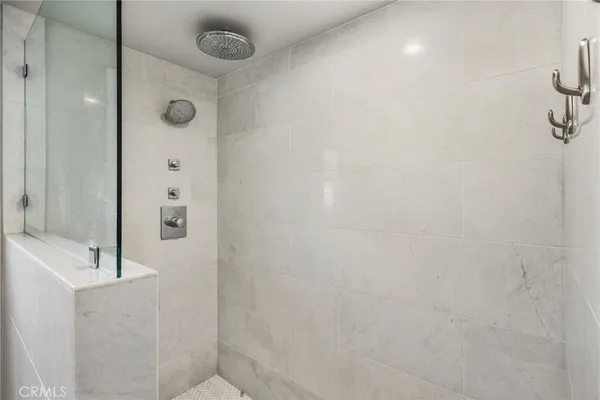 a bedroom with a bed mirror and window