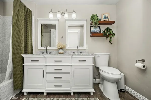 a bathroom with a granite countertop sink mirror and a bathtub