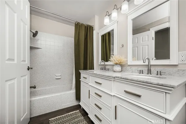 a bathroom with a granite countertop tub and a sink