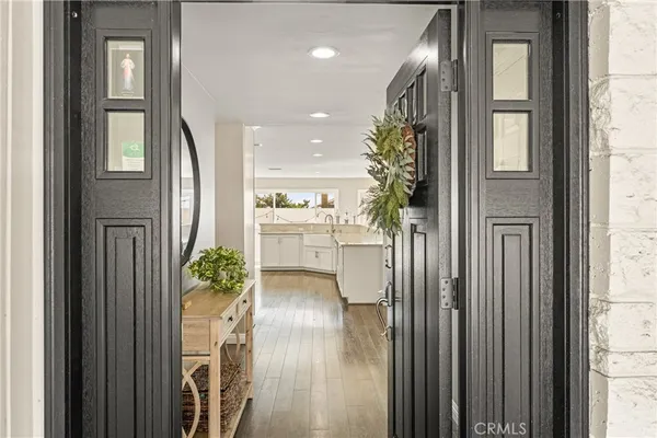 a view of entryway with a flower pot and a view of living room