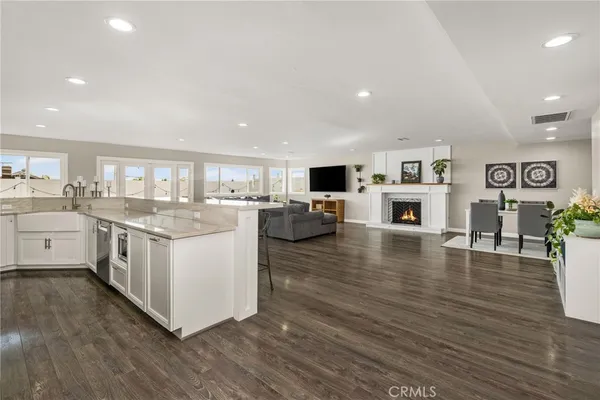 a kitchen with stove and wooden floor