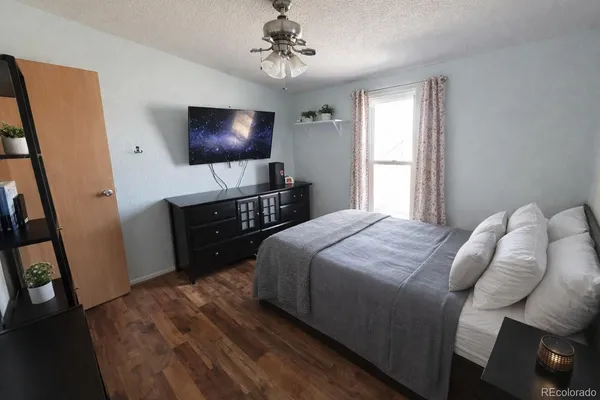 a bedroom with a bed and a flat screen tv