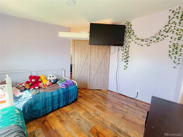 a bedroom with a bed and a couch