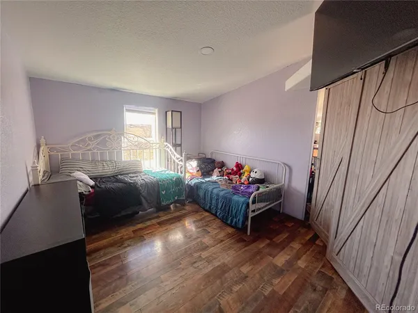 a bed sitting in a bedroom next to a cabinet