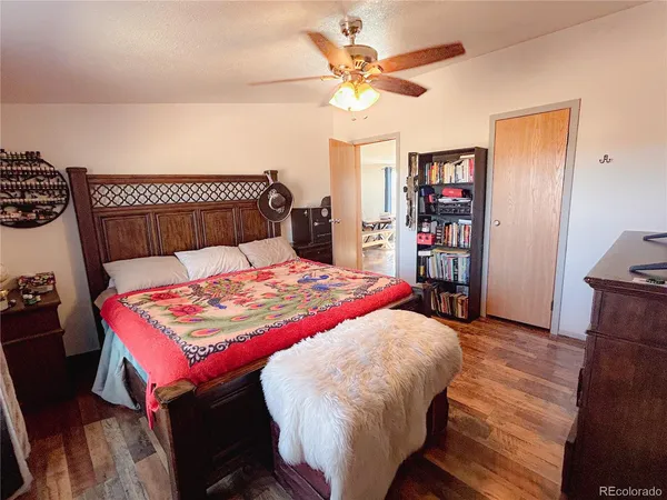 a bedroom with a bed dresser and a window