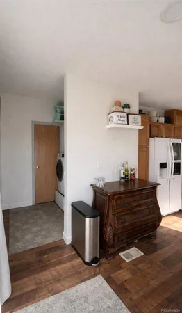 a living room with hard wood flooring and a couch