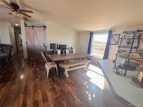 a work room with furniture and wooden floor