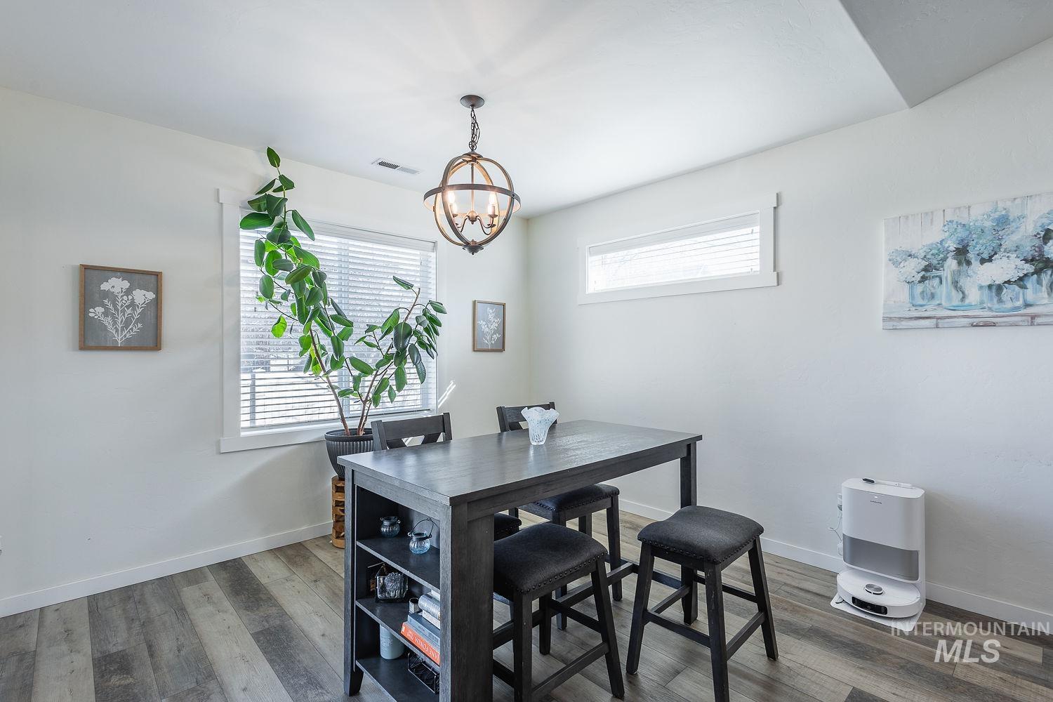 1332 West Raelin Drive Nampa, ID 83686 - Photo 20 of 48 Dining space with wood finished floors and suspended lighting