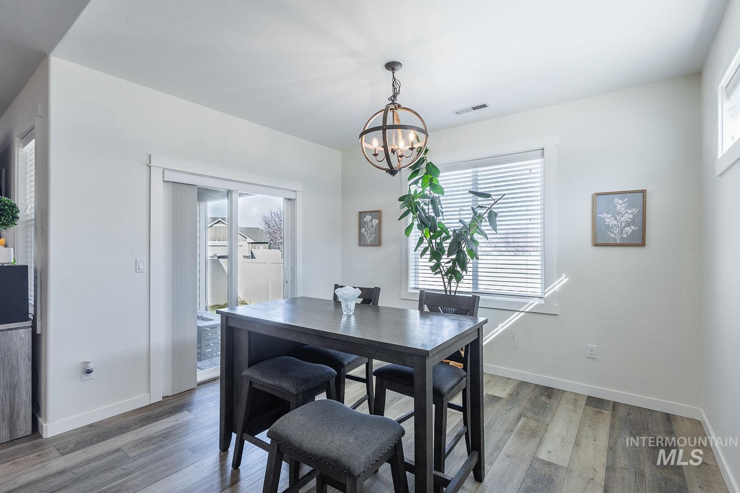 1332 West Raelin Drive Nampa, ID 83686 - Photo 21 of 48 Dining room with wood finished floors and a chandelier
